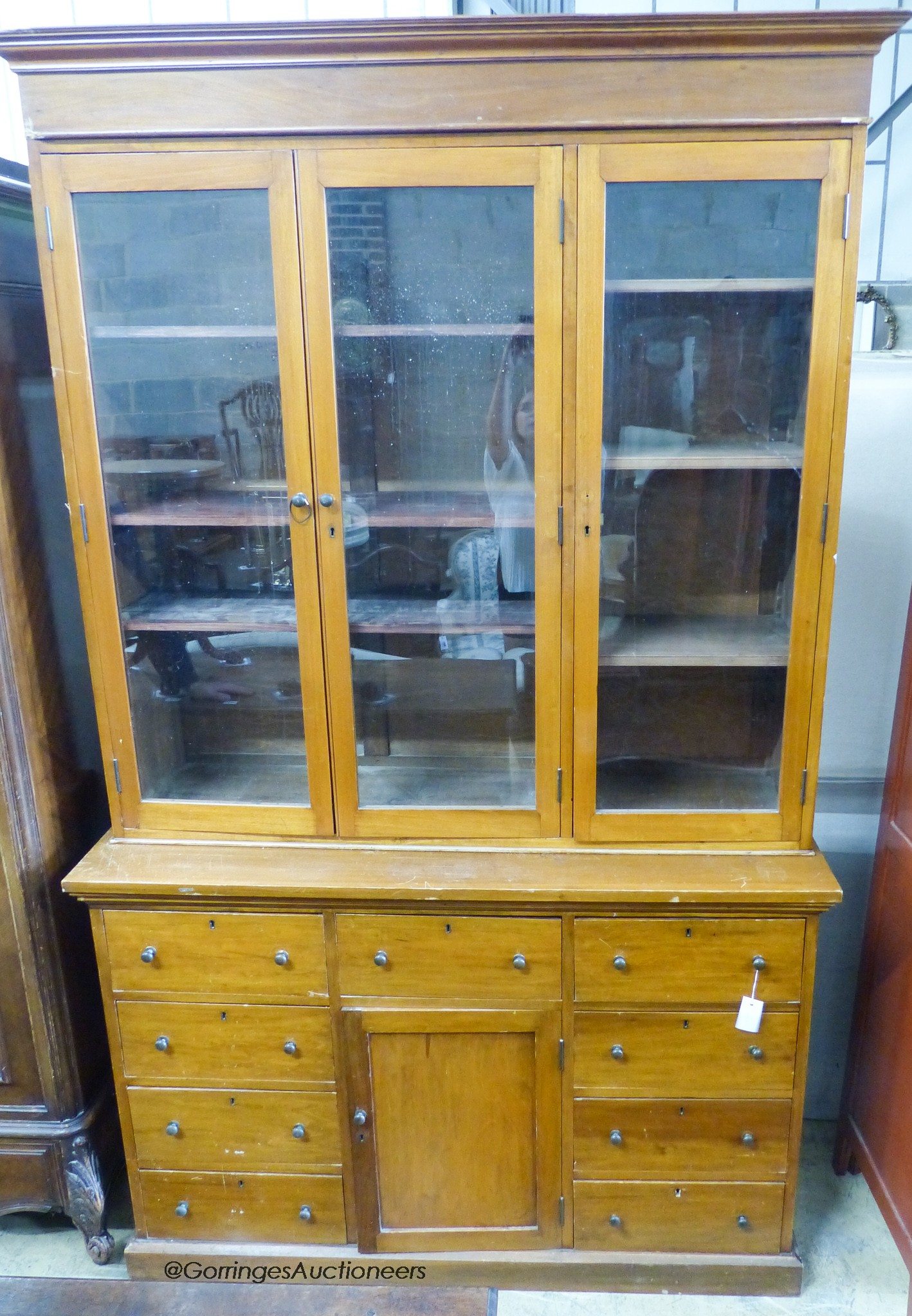 An early 20th century mahogany shopkeeper's bookcase cupboard. W-137, D-50, H-230cm.